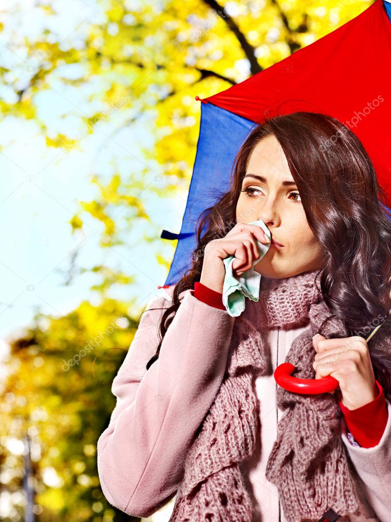 Woman sneezing handkerchief outdoor.