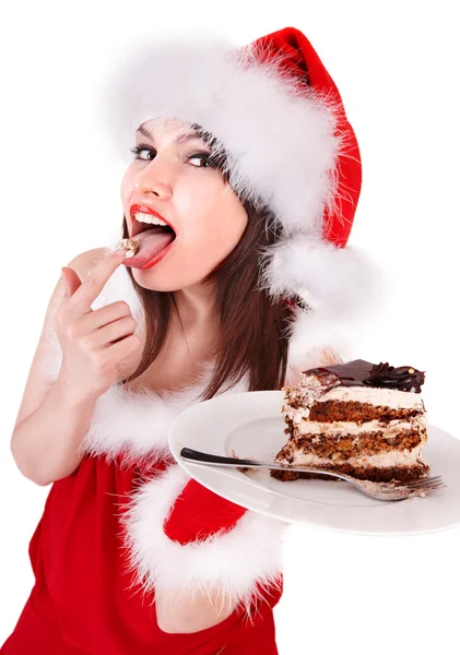 クリスマスの女の子のサンタ帽子プレートにケーキを食べる. — ストック写真