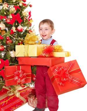 Çocuk Noel ağacının yanında hediye kutusu.