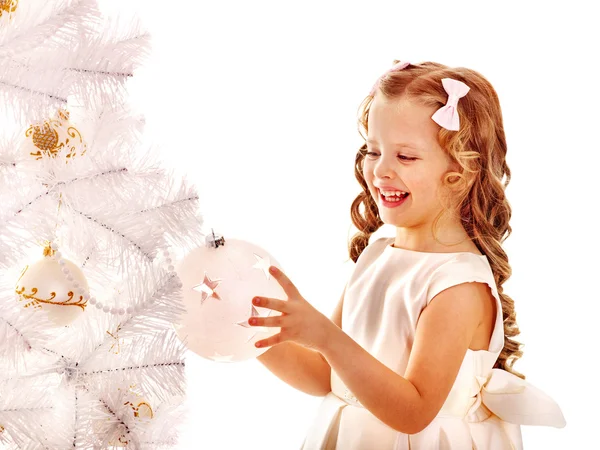 Child decorate white Christmas tree. Stock Picture