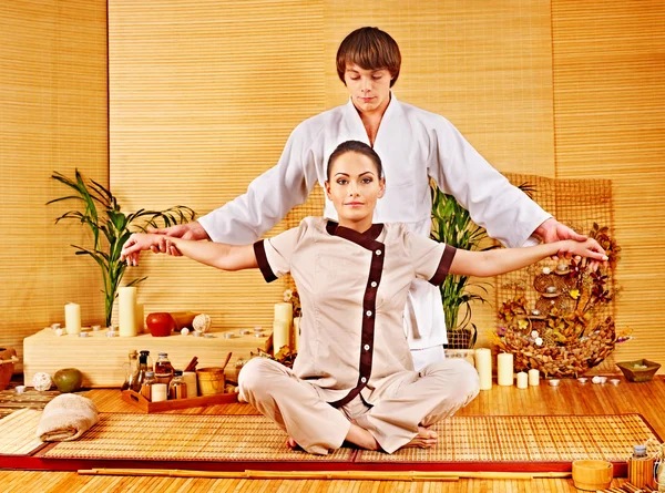 Male masseur doing massage woman in bamboo spa. — Stock Photo, Image