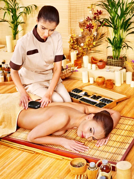 Woman getting stone therapy massage . Stock Photo