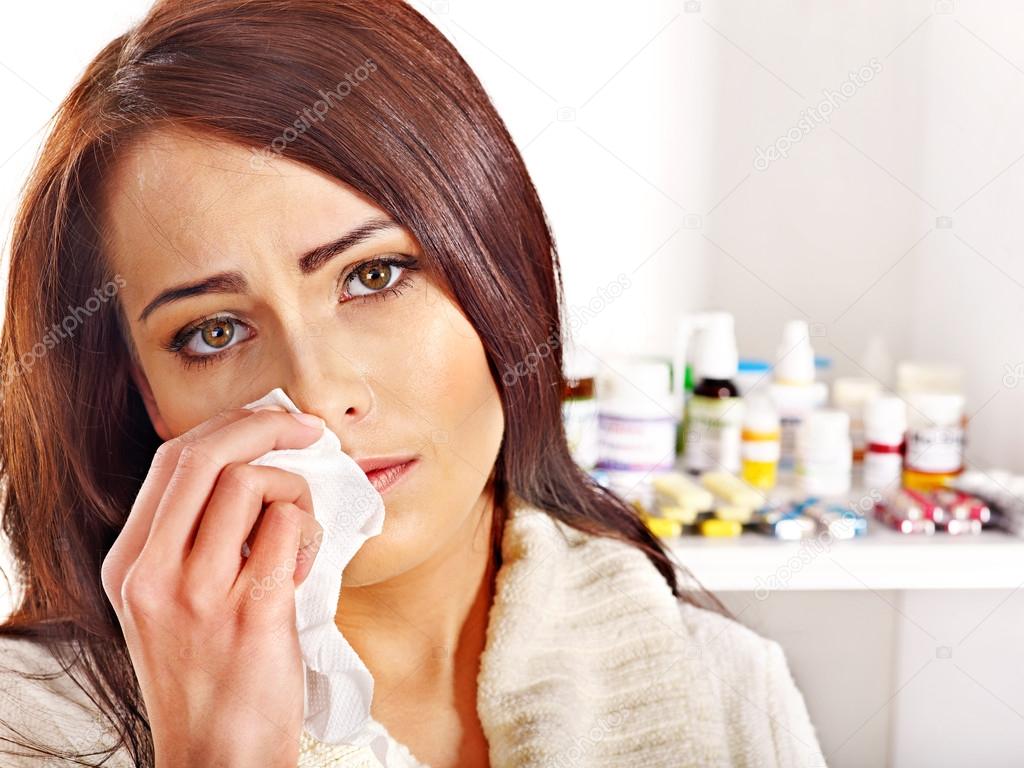 Woman with handkerchief having tablets and pills.