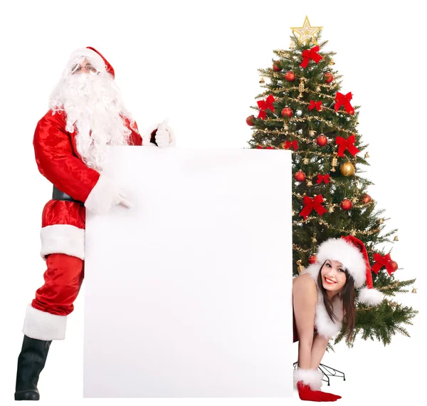 Santa Claus y niña sosteniendo pancarta por árbol de Navidad .. —  Fotos de Stock