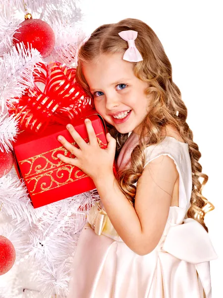 Дитина з подарунковою коробкою біля білої ялинки . — стокове фото
