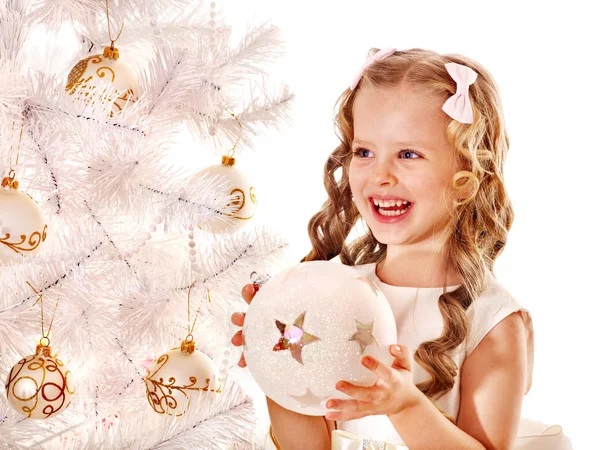 Child decorate white Christmas tree. Stock Photo