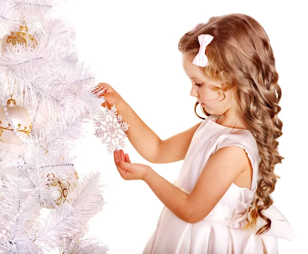 Child holding snowflake to decorate Christmas tree . Royalty Free Stock Images
