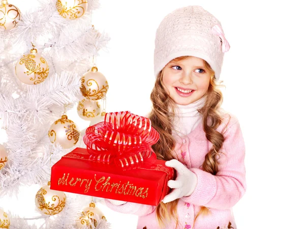 Child in hat and mittens holding Christmas red gift box . Royalty Free Stock Photos