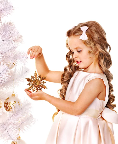 Child holding snowflake to decorate Christmas tree . Stock Picture