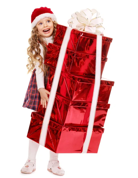 Kind in Weihnachtsmütze mit Stapel Geschenkschachtel. — Stockfoto