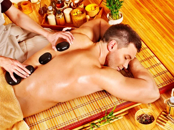 Man getting stone therapy massage . — Stock Photo, Image