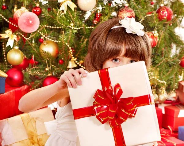 Child with gift box near Christmas tree. — Stock Photo, Image