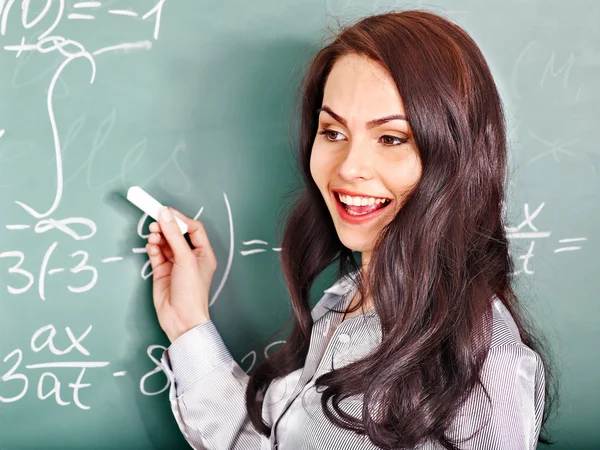 Schoolchild writing on blackboard. — Stock Photo, Image