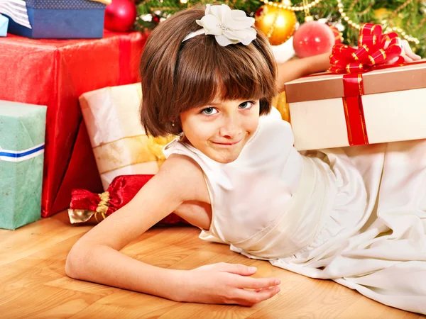 Child with gift box near Christmas tree. — Stock Photo, Image