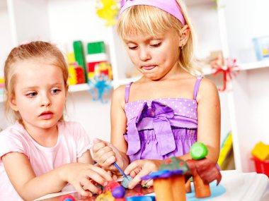 Child playing plasticine.
