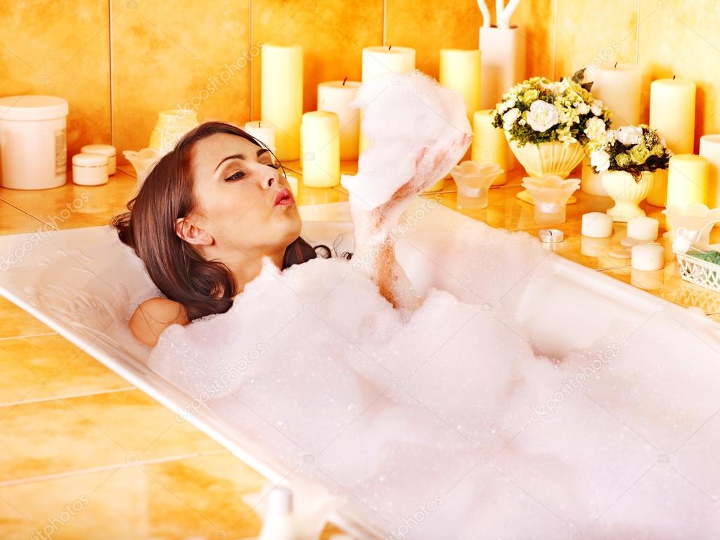 Woman relaxing at bubble bath.