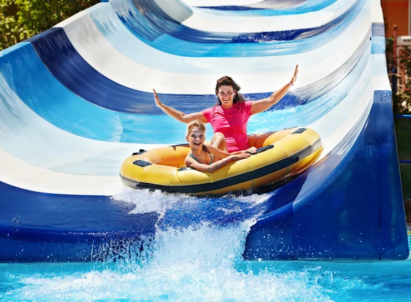 Child with mother on water slide at aquapark. — Stock Photo, Image