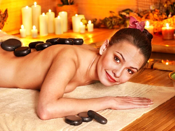 Woman getting stone therapy massage in bamboo spa — Stock Photo, Image