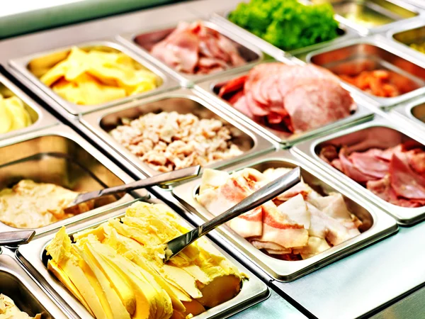 Tray with food on showcase at cafeteria — Stock Photo, Image