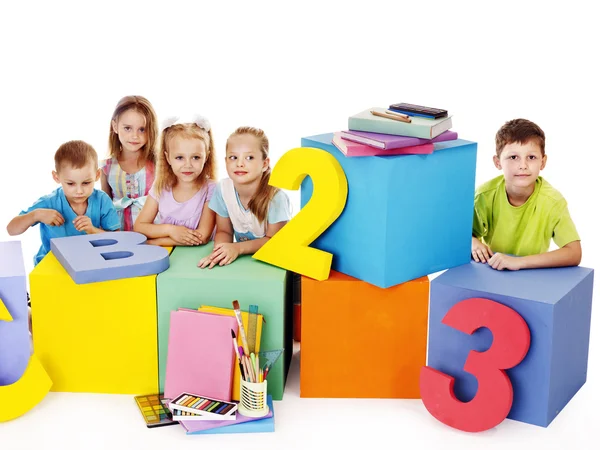 Children sitting at cube. — Stock Photo, Image