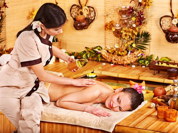 Woman getting massage in bamboo spa. — Stock Photo, Image