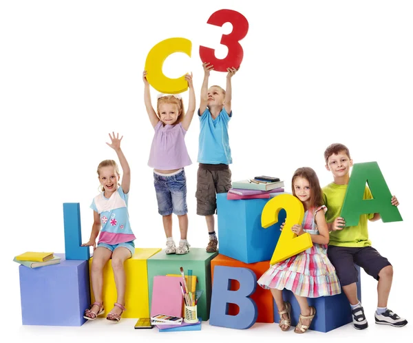 Children sitting at cube. — Stock Photo, Image