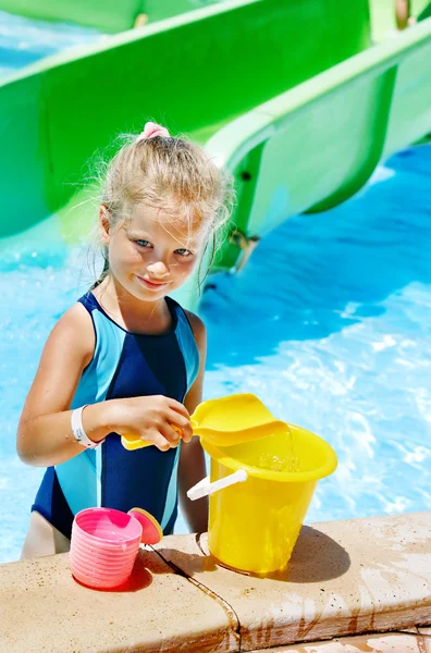 Child with bucket in swimming pool. — Stock Photo, Image