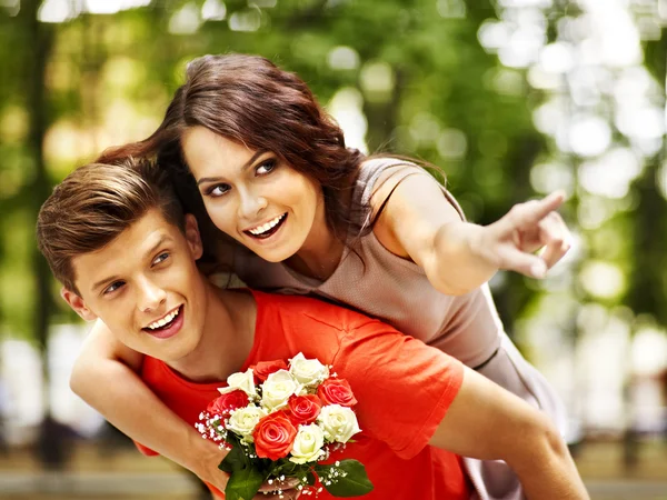 Couple with flower at park. — Stock Photo, Image