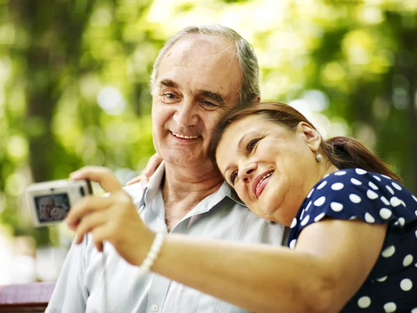 Happy old couple with flower. — Stock Photo, Image