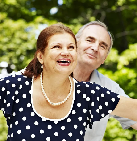 Happy old couple with flower. — Stock Photo, Image