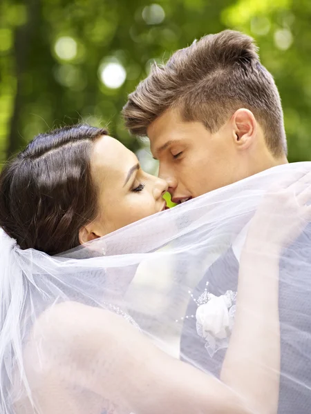 Bride and groom kissing outdoor. — Stock Photo, Image