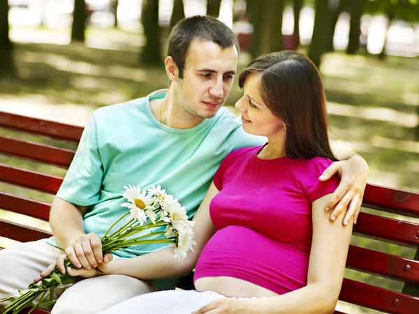 Pregnant woman with man outdoor. — Stock Photo, Image
