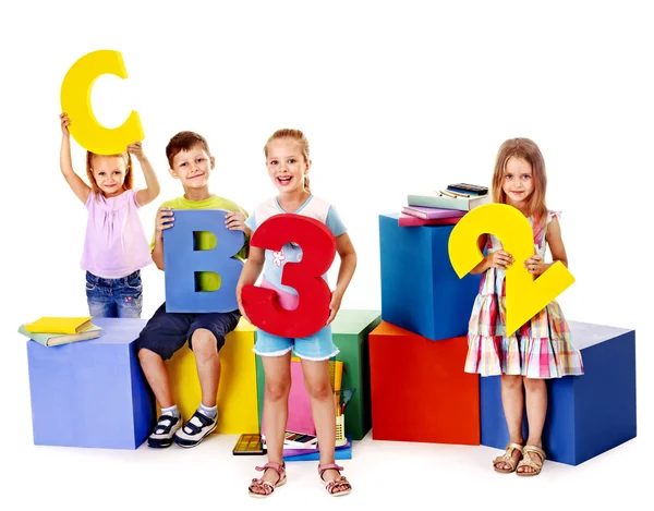 Children sitting at cube. — Stock Photo, Image