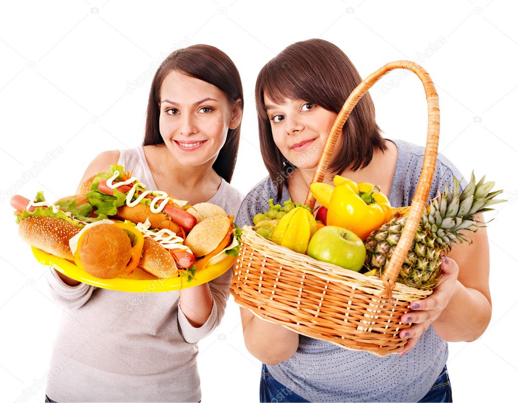 Women choosing between fruit and hamburger.