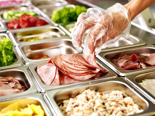 Tray with food on showcase at cafeteria — Stock Photo, Image