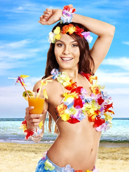 Frau im Hawaii-Kostüm trinkt Saft. — Stockfoto