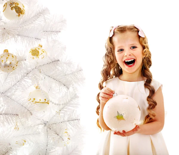 Child decorate white Christmas tree. Royalty Free Stock Photos