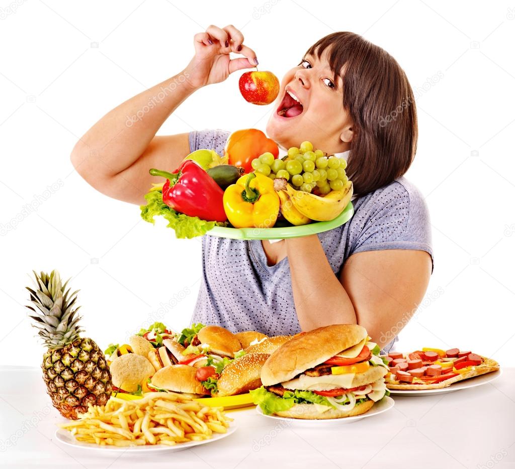 Woman choosing between fruit and hamburger.