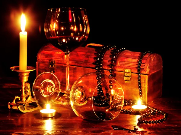 Wine glass and candle on dark — Stock Photo, Image