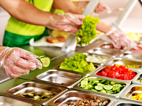 Tray with food on showcase at cafeteria