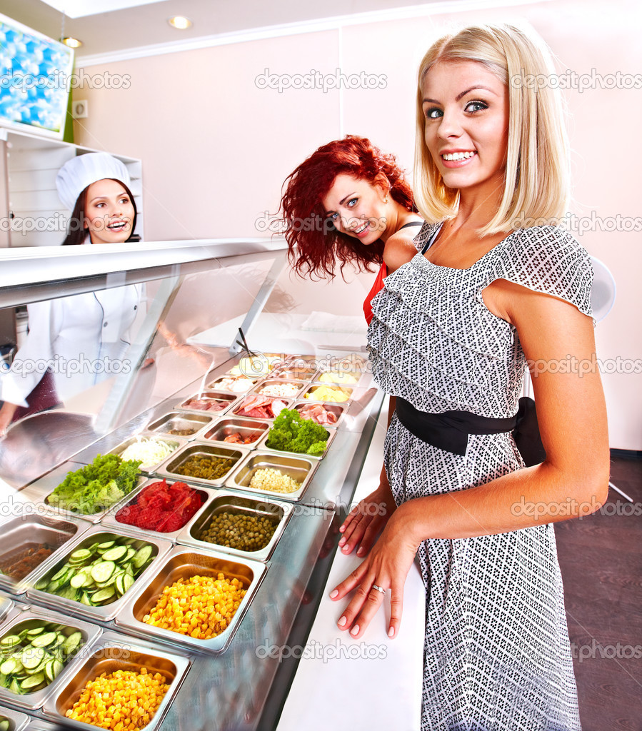 Young woman at cafeteria. — Stock Photo © poznyakov 33927115
