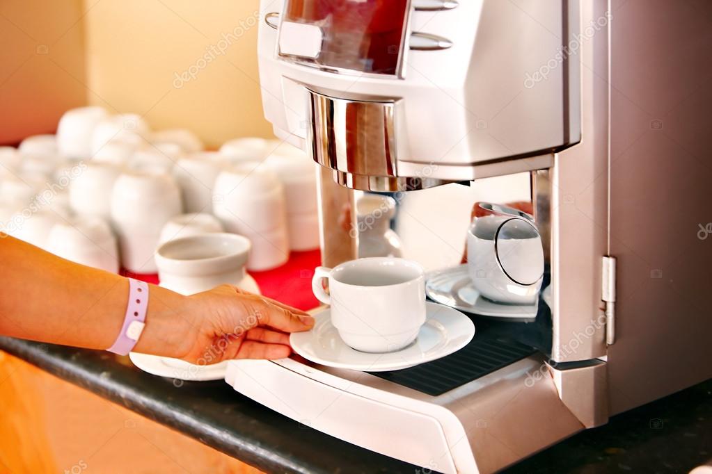Hand with coffee machine.