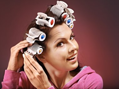Woman wear hair curlers on head. clipart