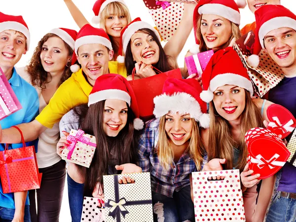 Girl in Santa hat holding Christmas gift box. Royalty Free Stock Photos