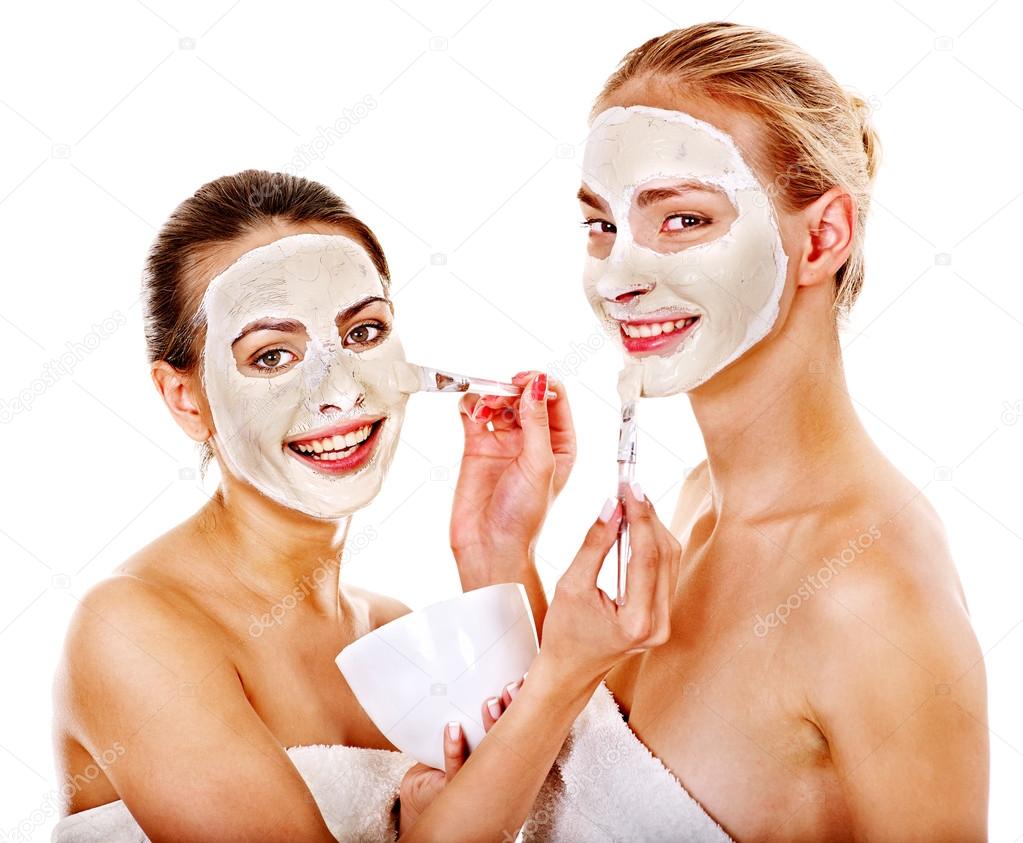 Woman getting facial mask.