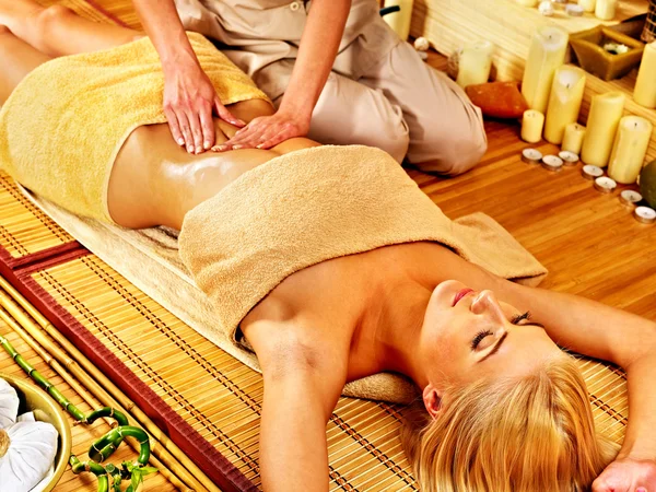 Woman getting massage in bamboo spa. — Stock Photo, Image