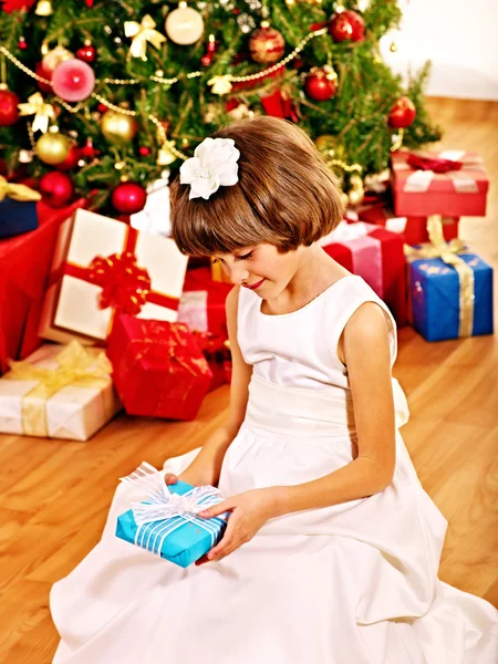 Child with gift box near Christmas tree. — Stock Photo, Image