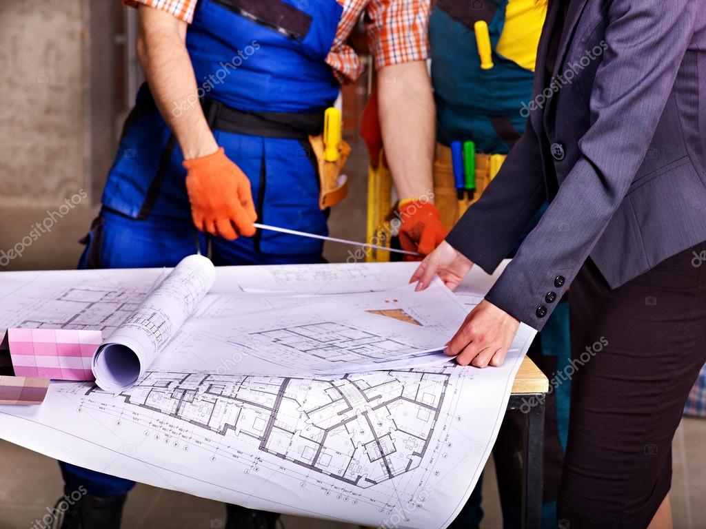 Business people and man in builder uniform
