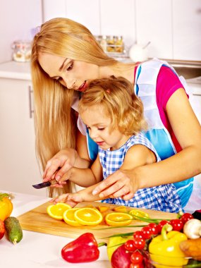 Mother and daughter at kitchen. clipart