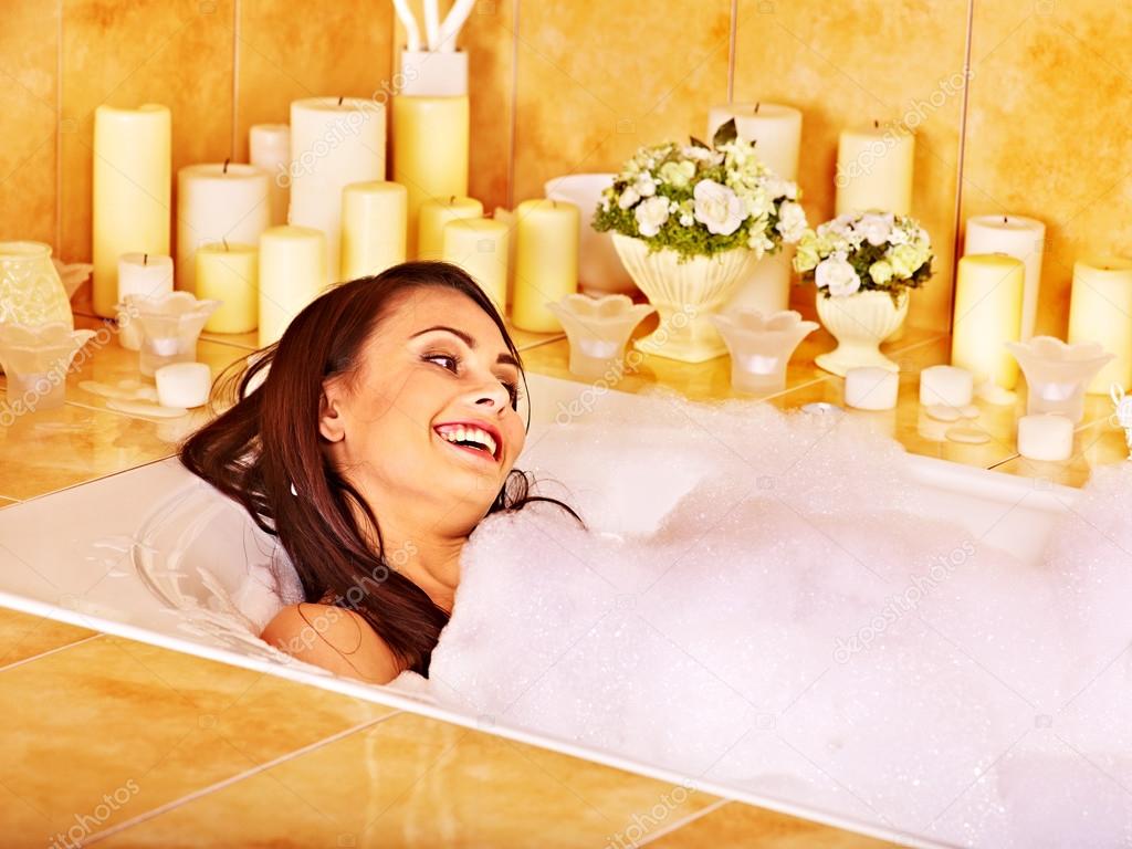 Woman relaxes at bubble bath.